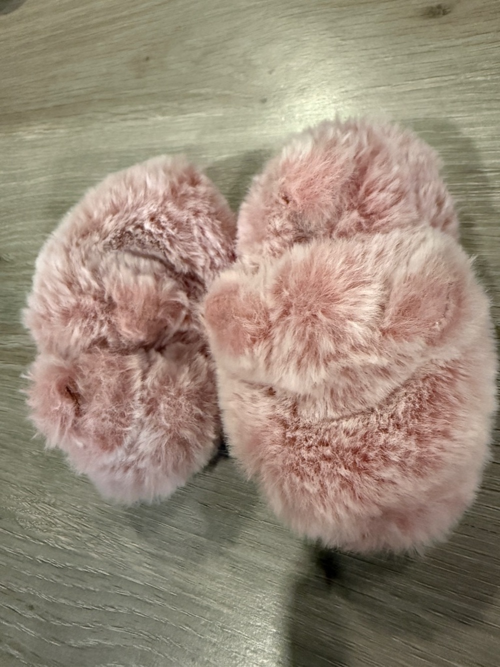 Fuzzy pink baby slippers